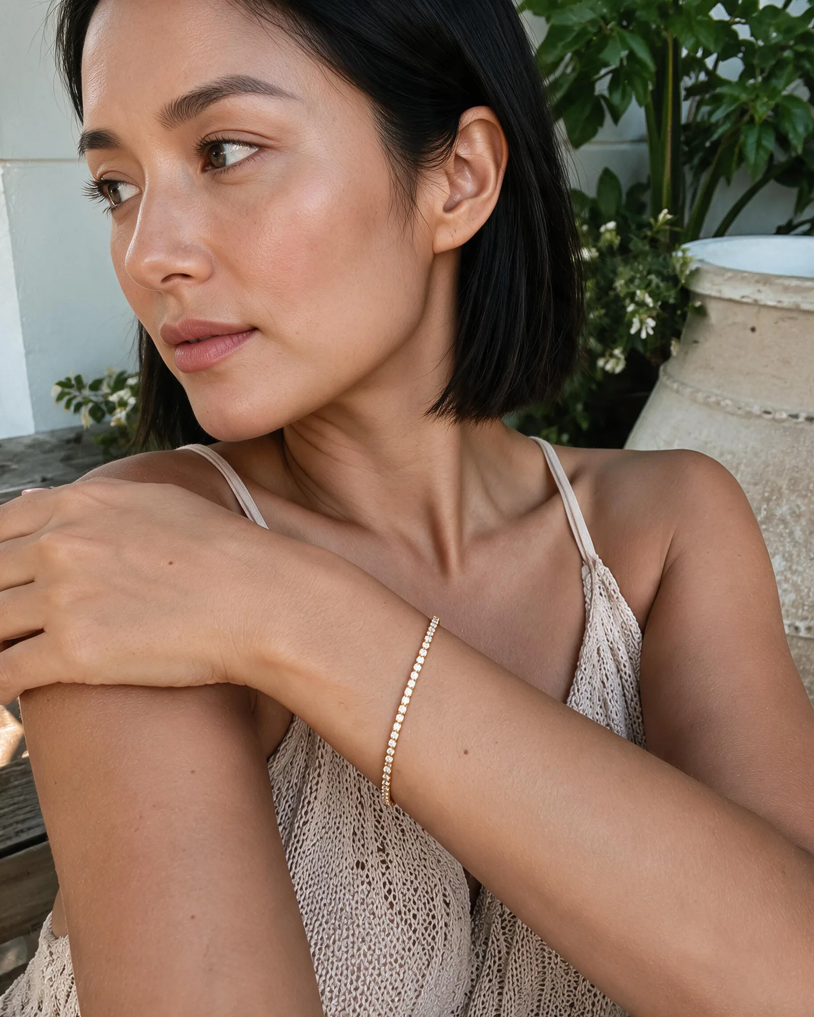 A diamond tennis bracelet worn on the wrist